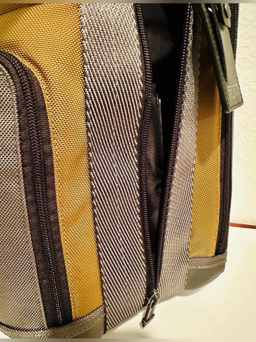 Brand New with Tag TUMI Higgins Sling Golden Brown Gray